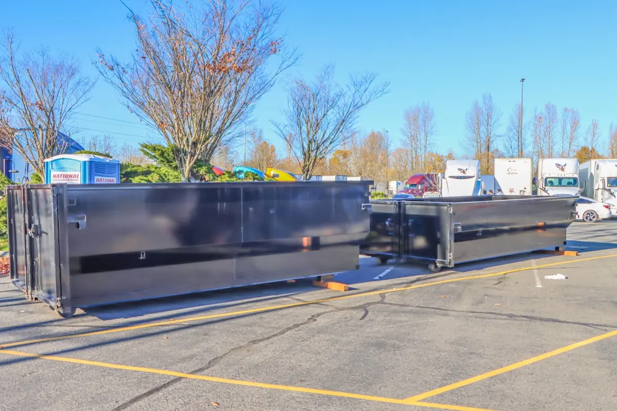 Professional dumpster rental service with roll-off container on residential driveway in Newport Beach